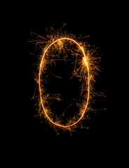 Digit 0 or zero made of bengal fire, sparkler fireworks candle isolated on a black background. Party dark backdrop
