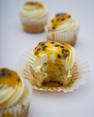 Bitten passion fruit cupcake on a marble background