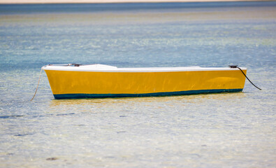Boat on the shore of a tropical island. Pleasure boat moored on the shore of the resort. Beautiful...