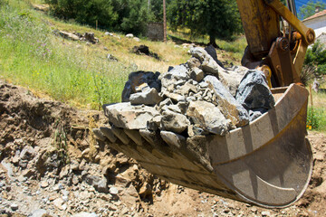 Digger bucket full of rocks