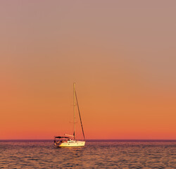 Yacht in a calm sea, a beautiful sunset, the calm. Waves.Beautiful photo.
