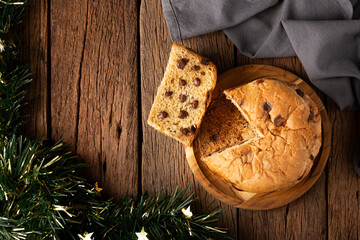 Delicious panettone with chocolate chips on a wooden table. Chocottone