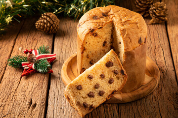 Delicious panettone with chocolate chips on a wooden table. Chocottone