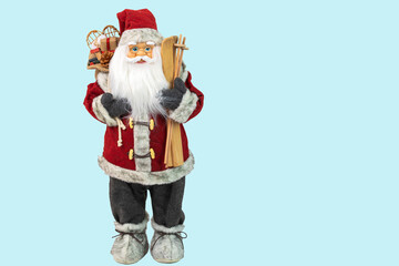 Close up view of a cute figure of Santa Claus with skis and a bag of gifts behind his back. Sweden.