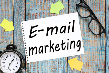 E-mail marketing. text on white paper on wooden blue background business concept