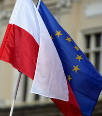 european union flag waves on wind together with flag of Poland