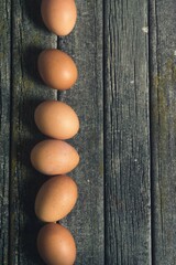 vertical placed eggs on an old wooden table