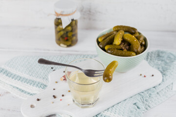 Pickled juice, pickle and marinated cucumber in bowl