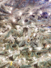 Christmas tree in the snow with a burning garland