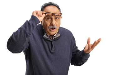 Confused mature man holding his glasses and gesturing with hand
