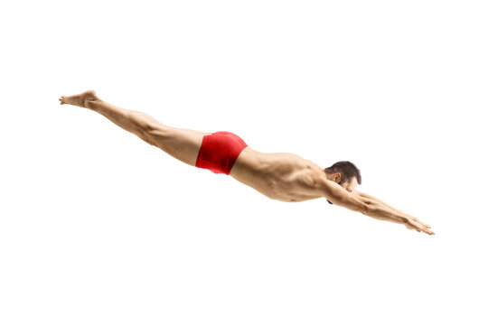 Male swimmer in a red swimsuit jumping to dive