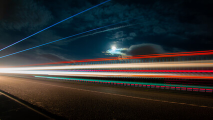 lights of cars with night. long exposure, moon and sky