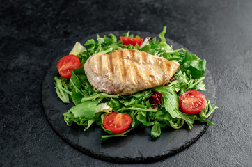 Grilled chicken breast and salad, Chicken meat with salad on a stone background. Healthy food.