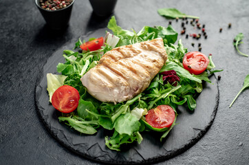 Grilled chicken breast and salad, Chicken meat with salad on a stone background. Healthy food.