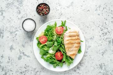 Grilled chicken breast and salad, Chicken meat with salad on a stone background. Healthy food.