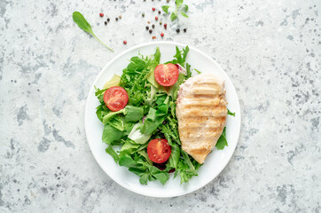 Grilled chicken breast and salad, Chicken meat with salad on a stone background. Healthy food.