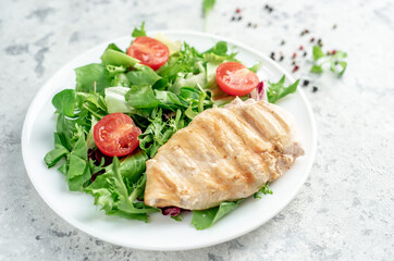Grilled chicken breast and salad, Chicken meat with salad on a stone background. Healthy food.