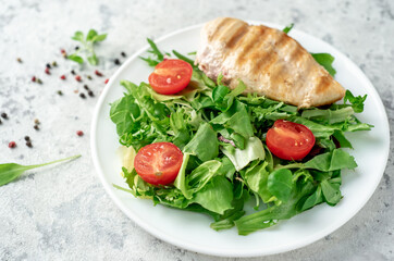 Grilled chicken breast and salad, Chicken meat with salad on a stone background. Healthy food.