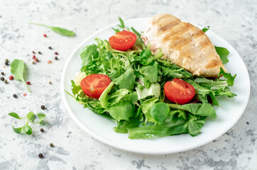 Fototapeta na wymiar Grilled chicken breast and salad, Chicken meat with salad on a stone background. Healthy food.
