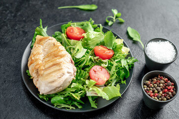 Grilled chicken breast and salad, Chicken meat with salad on a stone background. Healthy food.