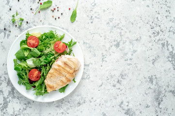 Grilled chicken breast and salad, Chicken meat with salad on a stone background. Healthy food. with copy space for your text