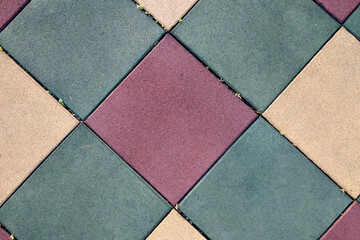Close up of soft rubber tiles for covering at outdoor gym of stadium at preschool yard.