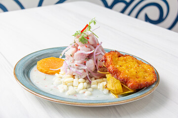 Peruvian eviction, accompanied by sweet potato, chili, corn cake.
