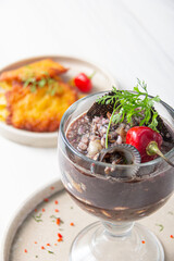 Panther milk, accompanied by black shells and fish.

