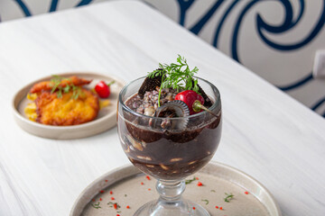 Panther milk, accompanied by black shells and fish.
