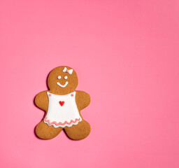 Christmas Gingerbread woman Cookie on a pink  background