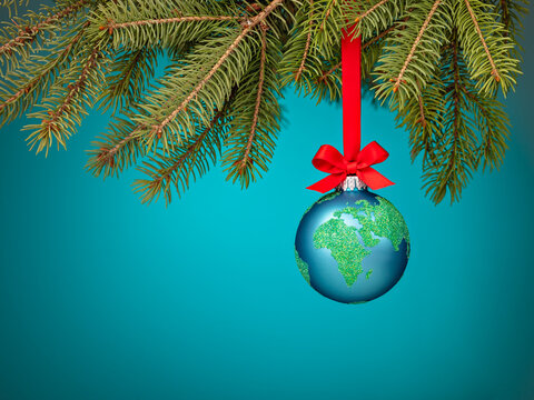 Globe christmas ball ornament hanging on a blue background
