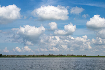 Summer cumulus clouds over the river