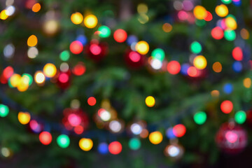 Blurred lights of the Christmas tree. Festive background.