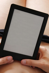 Woman holding and reading blank ebook