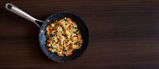Scrambled eggs on a wooden background