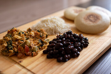 Venezuelan breakfast with arepa, white cheese, eggs and black beans