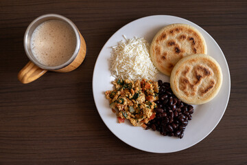 Venezuelan breakfast with arepa, white cheese, eggs and black beans