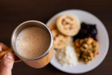 Venezuelan breakfast with arepa, white cheese, eggs and black beans