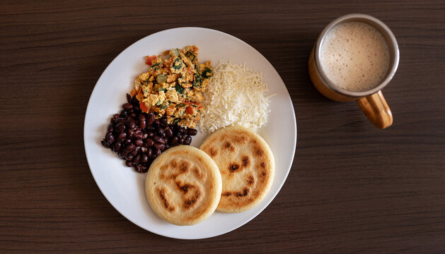 Venezuelan breakfast with arepa, white cheese, eggs and black beans