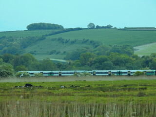 Rural landscape with a running train in the UK