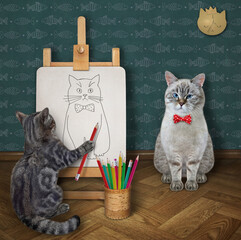 A gray cat artist with a pencil paints a portrait of an ashen cat on a canvas on an easel.