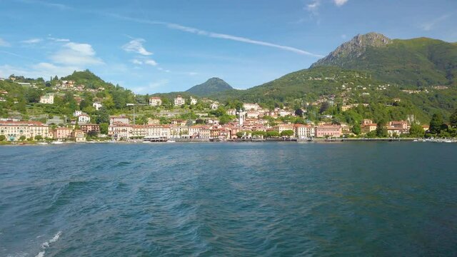 Short clip shot from a boat, sailing on Lake Como, from Varenna to Menaggio. It is a little overcast, but beautiful summer day. 4K
