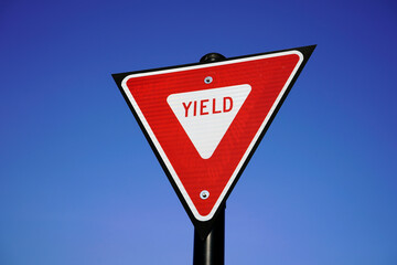 yield street sign on blue sky