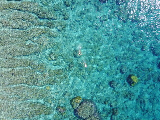 snorkel couple man woman girl boy summer vacation background with bubbles blue ocean waves corals coast explore adventure travel vacation island sunny Bali Indonesia Gili T drone view 
