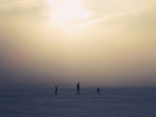 Fototapeta premium Silhouettes in the distance, snow