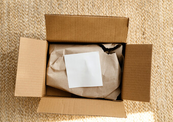 Overhead view of new parcel delivery unboxing on floor with white paper on the protected paper