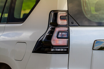 Modern rear light of a car. Brake light and arrow of large suv. Rear light of car close up view. Tail light.