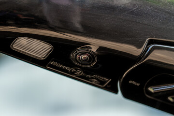 Close up view of surround view camera system on modern car side rear mirror. Blind spot and parking assistant camera.