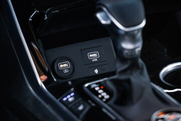 Fototapeta na wymiar USB port in the car panel close up. Car interior detail. Car usb charger detail.