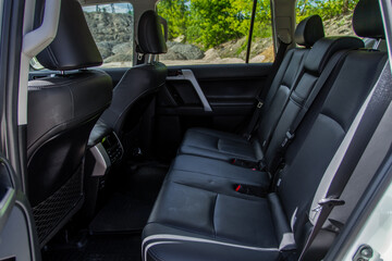 Modern SUV car inside. Leather black back passenger seats in modern luxury car. Comfortable leather seats.